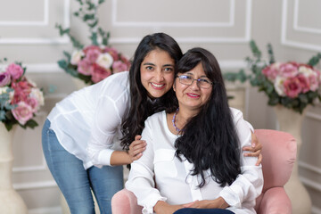 Mexican mother and daughter hugging on mother's day