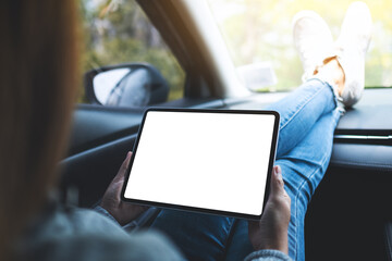 Mockup image of a woman holding and using digital tablet with blank screen in the car