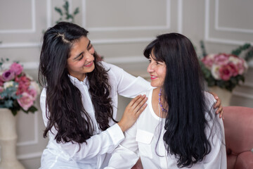 Mexican mother and daughter hugging on mother's day