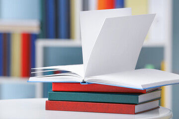 Stack of books on table in library