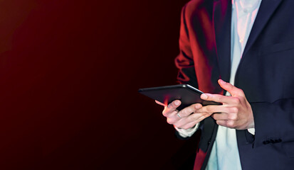 Man looking at tablet on black background.Selective focus