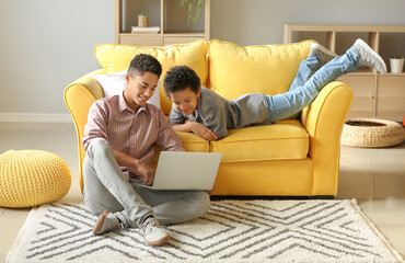 African-American boys using laptop at home