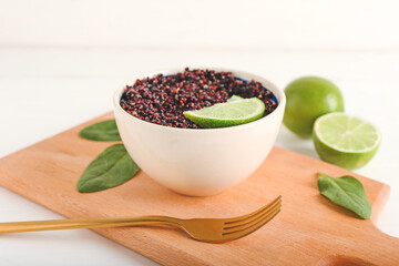 Composition with tasty quinoa and lime on white background