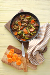 Tasty beef stroganoff with vegetables on color wooden background