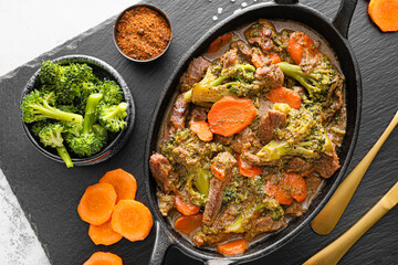 Tasty beef stroganoff with vegetables on table