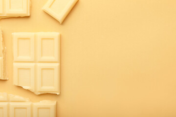 Tasty white chocolate on color background