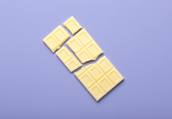 Tasty white chocolate on color background