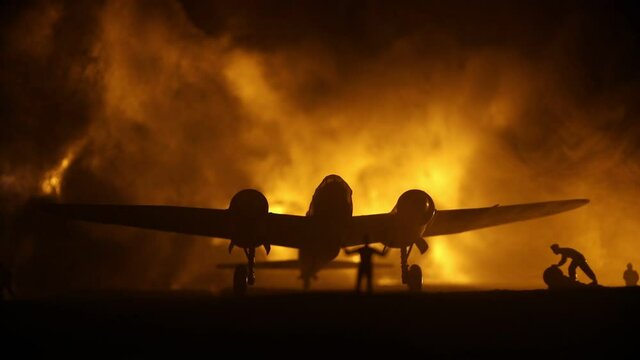 German Junker (Ju-88) night bomber at night. Artwork decoration with scale model of jet-propelled plane in possession. Toned foggy background with light. War scene. Selective focus