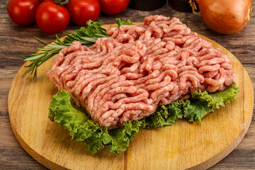 Raw pork minced meat over board