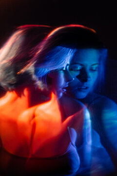 Female Hope. Art Silhouette. Faith Forgiveness. Double Exposure Abstract Portrait Of Pensive Thoughtful Worried Woman In Blue Red Neon Light On Dark Stained Texture Effect.