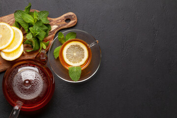 Obraz na płótnie Canvas Herbal tea with mint and lemon. Tea cup and teapot