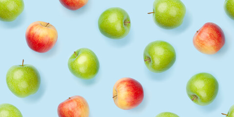 Green and red apple fruits over blue seamless