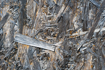 Old crumbling coloured chip-board texture or background