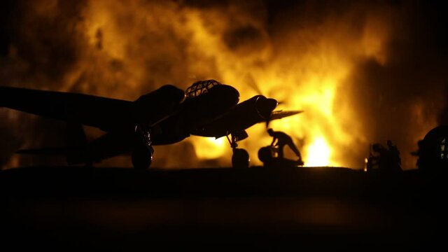 German Junker (Ju-88) night bomber at night. Artwork decoration with scale model of jet-propelled plane in possession. Toned foggy background with light. War scene. Selective focus