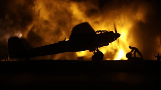 German Junker (Ju-88) night bomber at night. Artwork decoration with scale model of jet-propelled plane in possession. Toned foggy background with light. War scene. Selective focus