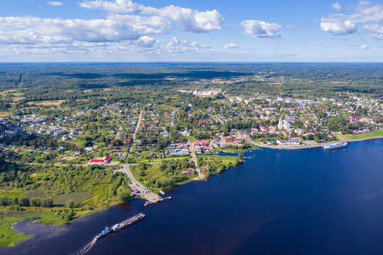 Aerial view of Myshkin town and ferry on Volga river on sunny summer day. Yaroslavl Oblast, Russia.
