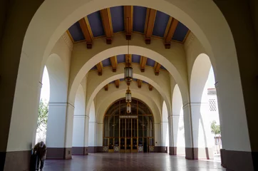  Famous Los Angeles sightseeing city skyline landmark Union train station in Art Deco and spanish Colonial architecture style breathtaking interiors and palm tree courtyard gardens with columns archway © Tamme