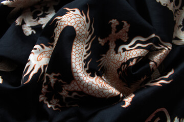 Satin dark fabric with Chinese ornament, clothing with a dragon, Asian style, texture on the Japanese theme, national clothing
