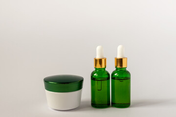 Moisturizer cream jar, serum in glass bottle on white background with copu space. Set for skin and...