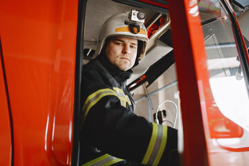 Firefighters in a fire truck in uniform