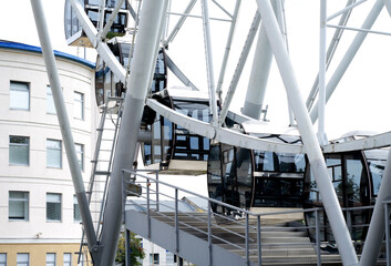 Glass booths of the Ferris wheel in the city park of Vladimir. Urban landscape concept, selective focus
