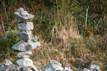 Very complicated balance stone tower on a stone fence. Concept concentration, passionate, stamina. Nature background