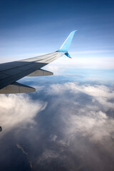 Airplane flying over the clouds and the Greek islands of the Mediterranean sea, Europe.