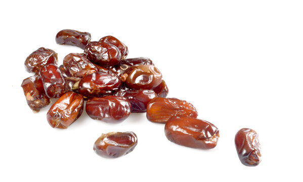 dried dates sprinkled on a white background