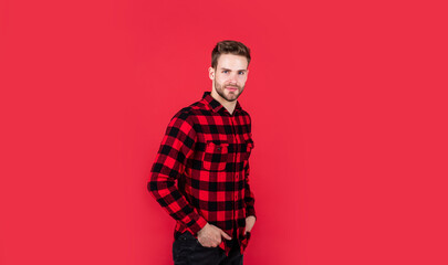 young handsome man in checkered shirt has bristle on face, style
