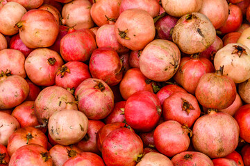 Many pomegranates for sale at the market. Fruit background