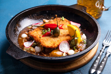 Tasty meat schnitzel in a frying pan