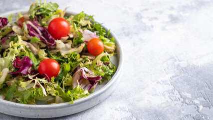 Healthy salad with mix  fresh lettuce and tomatoes. Diet food concept. Copy space