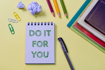 Do It For You motivational message written in notepad placed on yellow background with stationery supplies. 