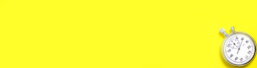 Mechanical stopwatch on a yellow background. - obrazy, fototapety, plakaty