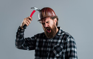 male worker in uniform with hammer. builder guy with working tool. brutal mature hipster