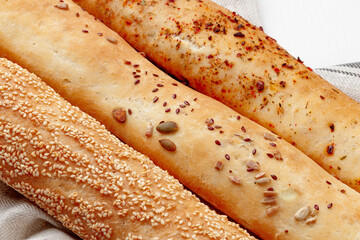 Fresh baguette bread on white wooden table
