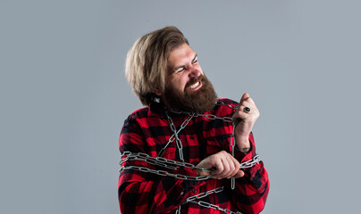 Painful procedure. male charisma and brutality. masculinity. guy with long beard hold chain