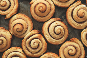 Fototapeta premium Cinnamon rolls, homemade cakes straight from oven.