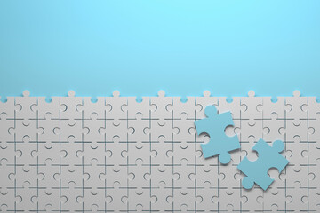 Composition with jigsaw puzzle small pieces and two large blue pieces. Image with copy blank space