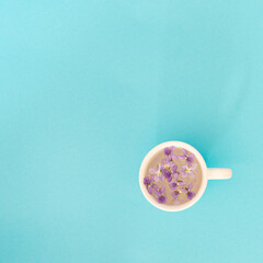 spring flower purple in a coffee cup.minimal concept flat lay