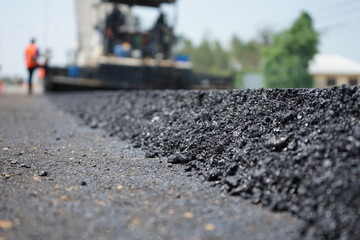 The image is blurred in the construction of asphalt road.