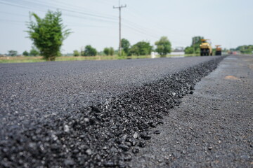 The image is blurred in the construction of asphalt road.