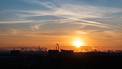 Fototapeta na wymiar Dawn over a smoking city