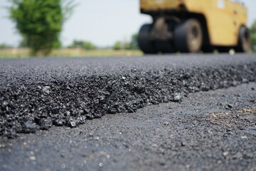 The image is blurred in the construction of asphalt road.