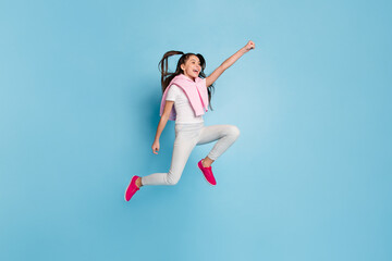 Full length body size view of pretty cheerful girl jumping striving having fun isolated over bright blue color background