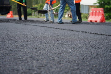 The image is blurred in the construction of asphalt road.