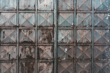 Texture of old worn metal gate as background