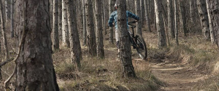 Mtb biker man push freeride enduro bike uphill walking on sport trail