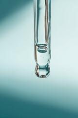 A drop of cosmetic oil falls from the pipette