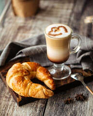 Breakfast with french croissant and mug of coffee latte